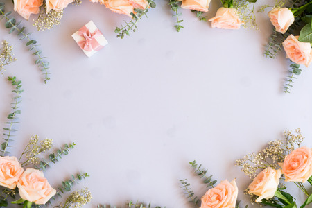 gift or present box and flowers on blue background from above, copy spaceの写真素材
