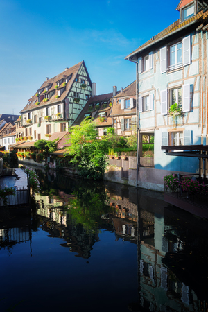 half timbered crooked houses of Colmar with reflections in water, Alsace, Franceの写真素材