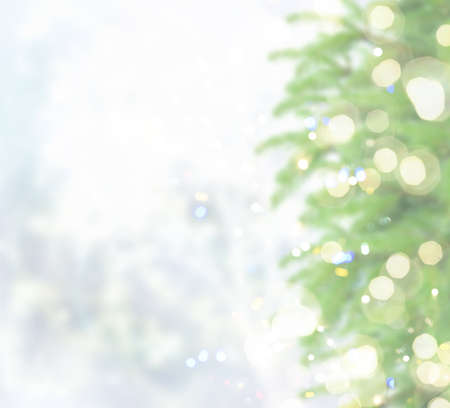 christmas defocosed background with fir tree, bokeh lights and snow