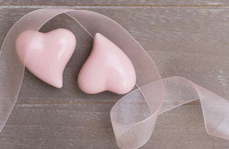 Two pink hearts for Valentines Day on gray wooden backgroundの写真素材