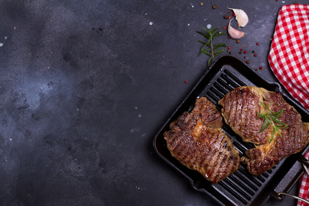Hot Grilled beef steak on dark background with red and white napkin, copy space on dark backgroundの写真素材