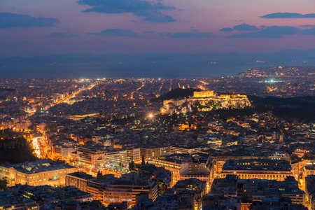 panoramic cityscape of Athens with Acorpolis hill and sea at night, Greeceの写真素材