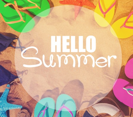 Summer beach fun - frame on sand with sandals and swimming suits with hello summer greeting