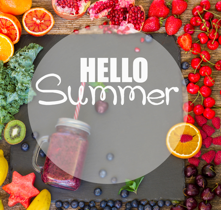Fresh smoothie blue berry healthy drink in glass jar with igredients on black stone with hello summer greetingの写真素材