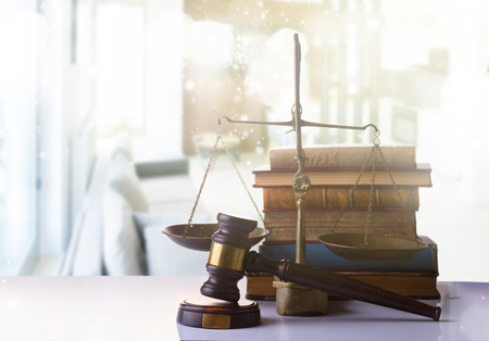 Law and justice concept - law gavel with scale and row of books on white abstract backgroundの写真素材