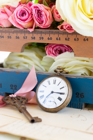 antique vintage pocket clock and fresh flowersの写真素材