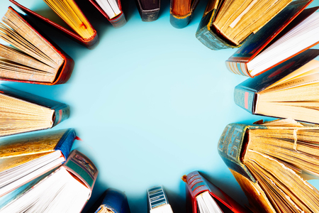 Frame of old books on blue background with copy space, retro tonedの写真素材