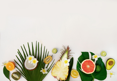 fresh fruits with green tropical leves flat lay top view border, summer diet background with copy spaceの写真素材