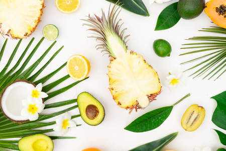 fresh fruits with green tropical leves flat lay pattern, summer healthy diet backgroundの写真素材