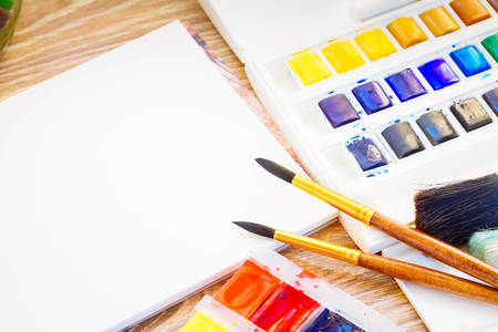 white empty canva with brushes and watercolor paints on table, retro tonedの写真素材
