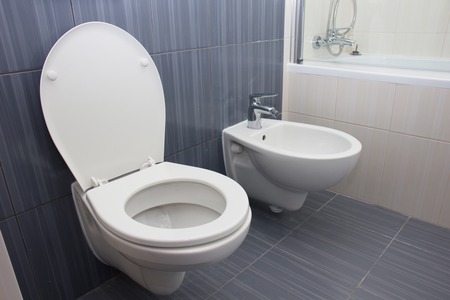 Modern white wc and bidet bowl in bathroom toilet close upの写真素材