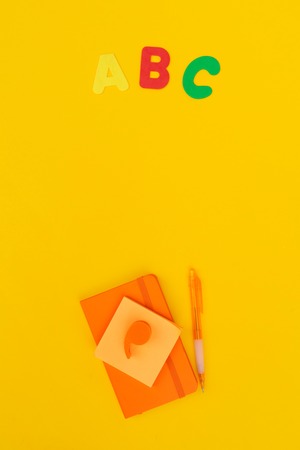 Back to school styled scene with abc and school supplies on yellow backgroundの写真素材