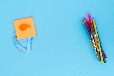 Back to school styled school supplies on blue background with copy spaceの写真素材
