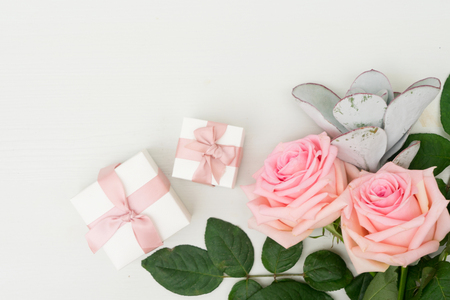 Two Rose fresh flowers on table from above with gift boxes and copy space, flat lay sceneの写真素材