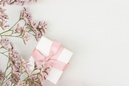 violet flowers on table from above with gift box, flat lay sceneの写真素材