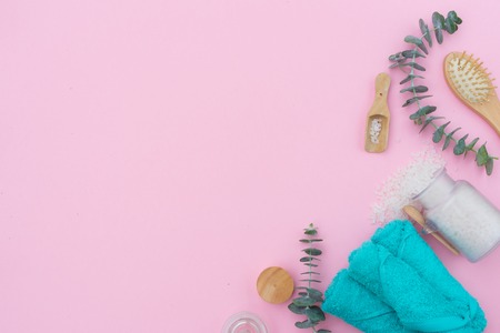 Beauty background with a natural soap, cream, towels and cotton buds on pink, falt lay with copy spaceの写真素材