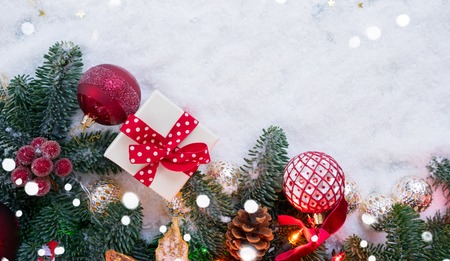 Christmas evergreen tree decorated with golden and red balls in white snow, christmas flat lay scene