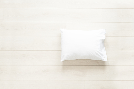 pillow in white linen on the wooden floor backgroundの写真素材