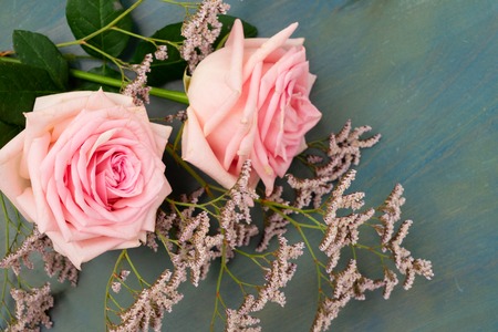 Rose fresh flowers on blue table from aboveの写真素材