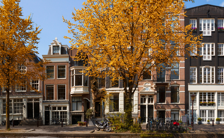 old houses over canal in Amsterdam at fall, Netherlandsの写真素材