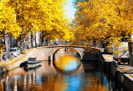 bridge of Amsterdam over canal ring landmark in old european citye, Holland Netherlands. Amsterdam fall scenery with tree lush.の写真素材