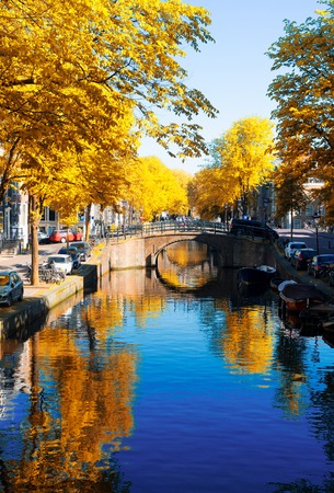 bridge of Amsterdam over canal ring landmark in old european citye, Amsterdam fall scenery with tree lushの写真素材