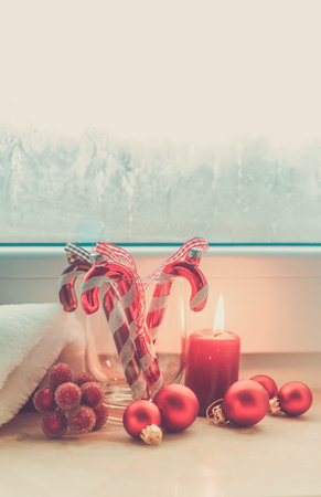 Christmas scene with red burning light on windowsill, vertical shot retro tonedの写真素材