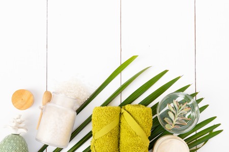 Beauty background with spa cosmetic products, succulents and flowers on white wooden background, top...