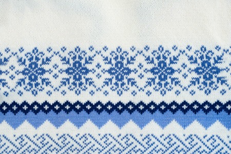 Texture of blue and white traditional winter sweater backgroundの写真素材