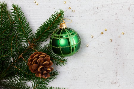 Evergreen twigs with ball and cone, flat lay border with copy spaceの写真素材
