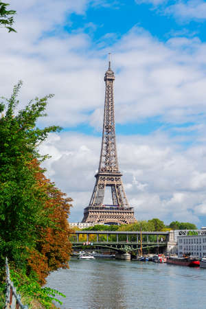 famous Eiffel Tour over Seine river with green trees, Paris, Franceの写真素材