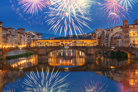 Ponte Santa Trinita bridge with reflection in the Arno River at night with fireworks, Florence, Italyの写真素材