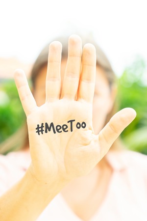 Woman holding palm with #MeToo letters, concept of protests against sexual harassmentの写真素材