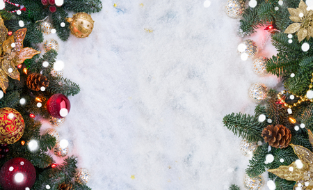 Christmas decorated evergreen tree with lights flat lay frame scene with copy space on snowの写真素材