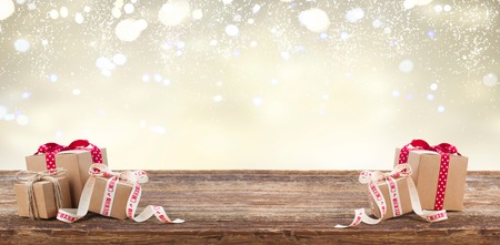 Present boxes with gfts on wooden table, banner with copy space