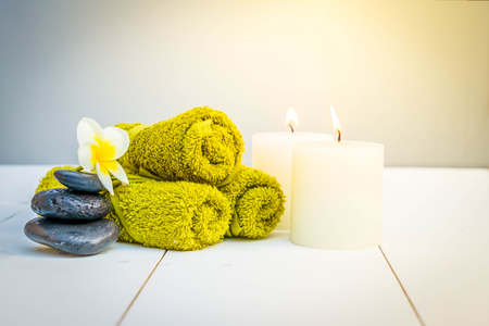 Beauty spa background with burning candles and black massage stones, retro tonedの写真素材