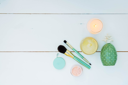 Beauty background with facial cosmetic products with succulents and make up brushes on blue wooden background with copy space, retro tonedの写真素材