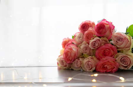 Pile of rose fresh flowers bouquet on gray tableの写真素材