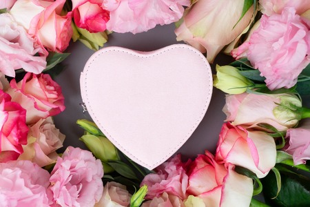 Rose fresh flowers bouquet on gray table from above, flat lay scene