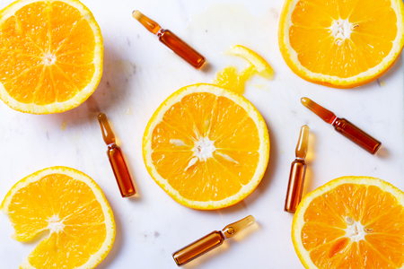 Vitamin C, natural treatment concentrate with slice of orange fruits conceptの写真素材