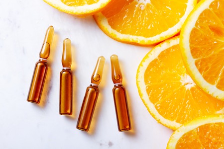Vitamin C, natural treatment concentrate with slice of orange fruitsの写真素材