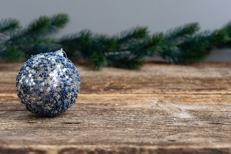 Gray christmas ball on natural wood table backgroundの写真素材