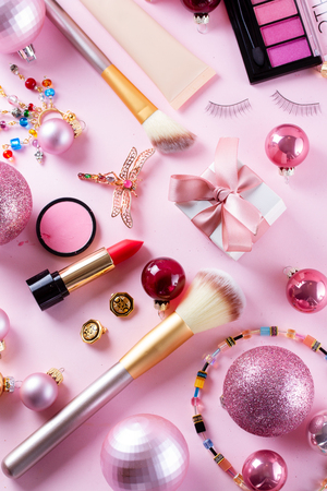 Festive make up brushes and products on pinkの写真素材