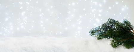 Evergreen fir tree in snow with glowing lightsの写真素材