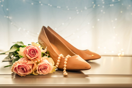 Female high heel shoes with fresh pink rose flowers, retro tonedの写真素材