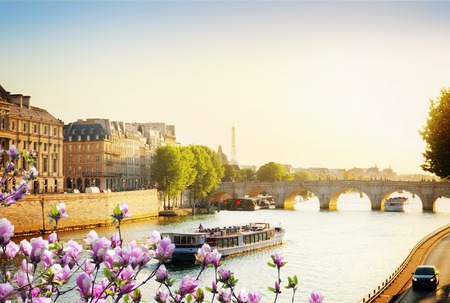 Pont Neuf and Seine river with tour boat at sunny spring sunset, Paris, Franceの写真素材