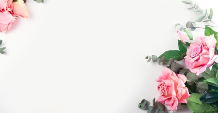 Pink Roses with leaves, flat lay flower frame on white  bannerの写真素材