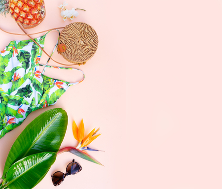 Summer flat lay scenery with beach accessories border on pink background, top view with copy spaceの写真素材