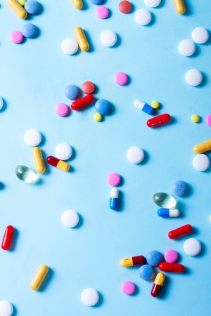 Assorted medical pills on blue background, top viewの写真素材