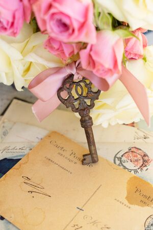 antique rusty skeleton key with flowers on handwritted mailの写真素材